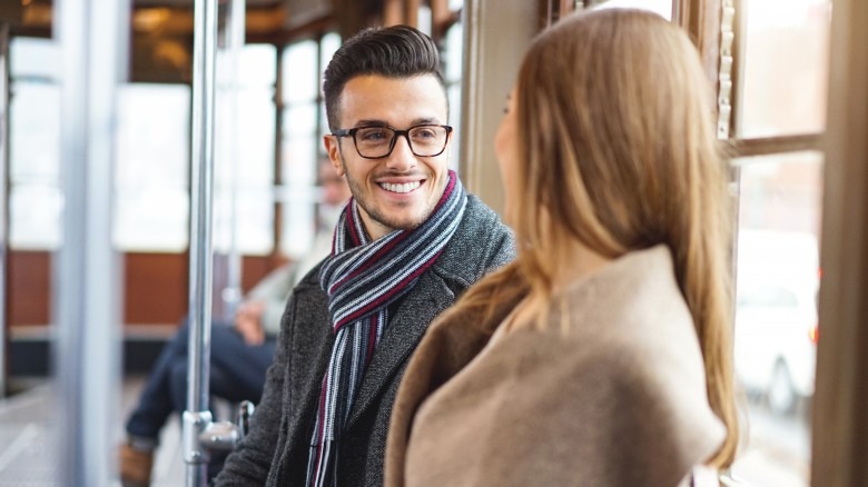 Man and woman talking on a train