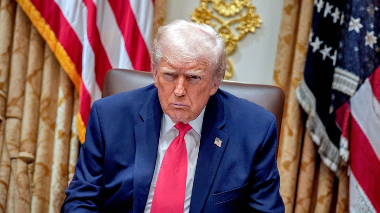Trump furrowing his brow while sitting in the Oval Office