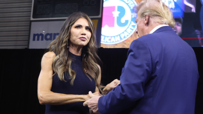 Kristi Noem and Donald Trump shaking hands