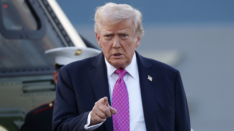 Donald Trump pointing in pink tie