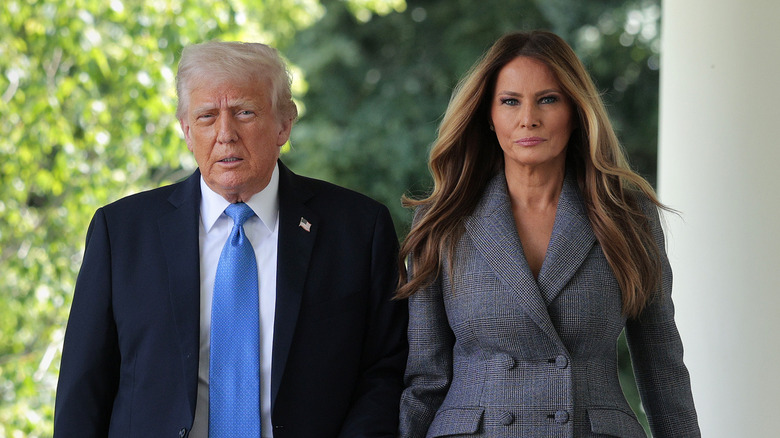 Donald Trump walks with wife Melania Trump