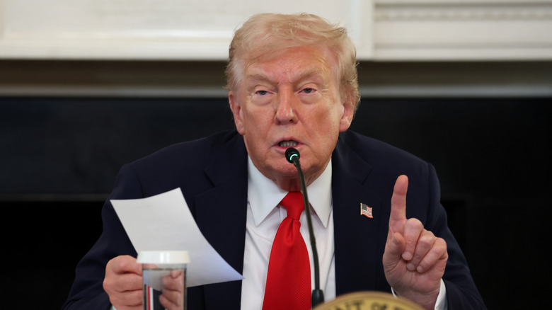 Donald Trump giving a speech while holding his finger up