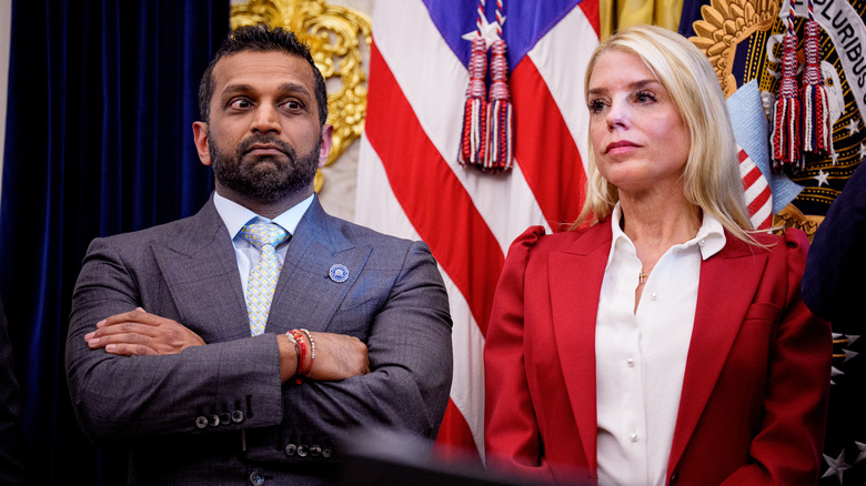 Kash Patel standing next to Pam Bondi with his arms crossed