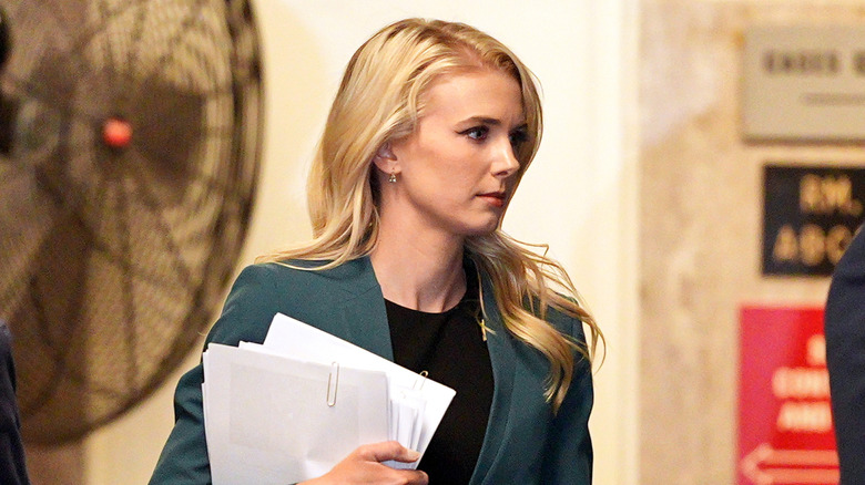 Natalie Harp holding a stack of papers