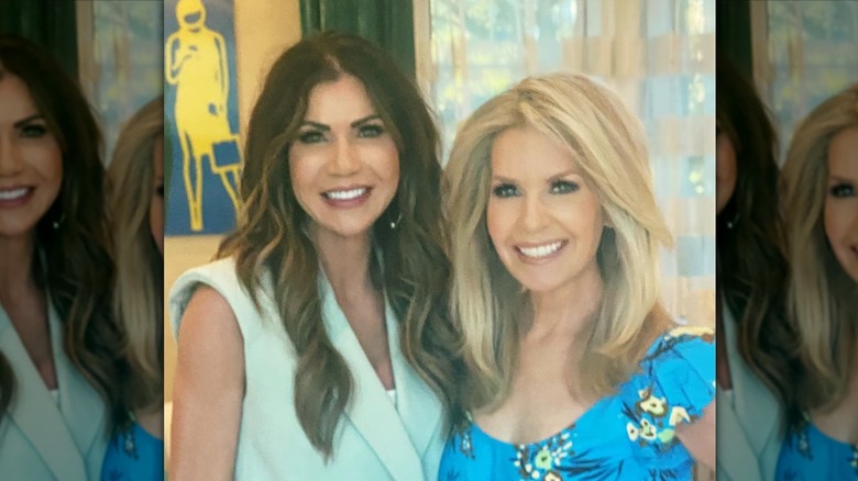 Monica Crowley poses with hand on hip and arm around Kristi Neom.