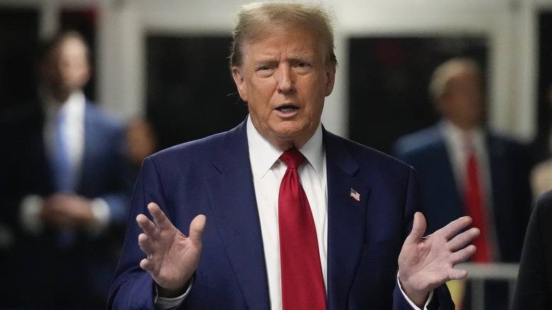 Donald Trump hands open outside courthouse