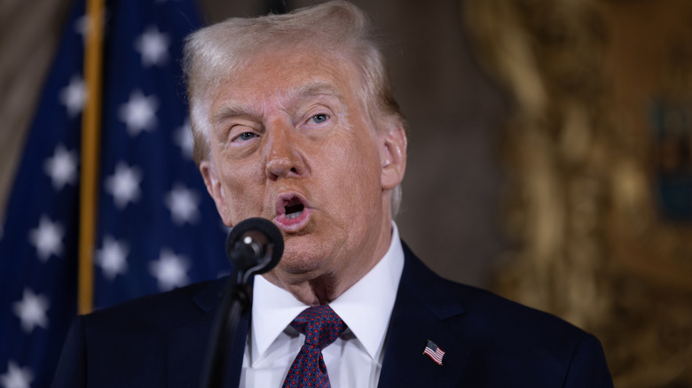 Donald Trump speaking into a microphone