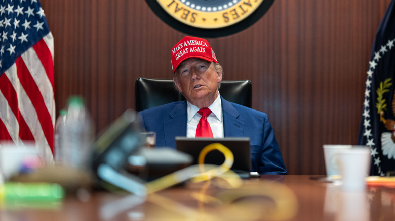 Donald Trump in the Situation Room wearing a red MAGA hat