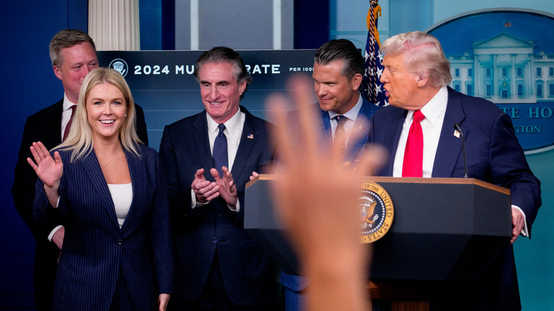 Donald Trump speaking to Karoline Leavitt at press conference