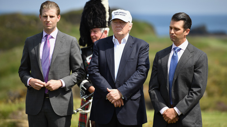 Donald Trump walking with his sons, Eric Trump and Donald Trump Jr.