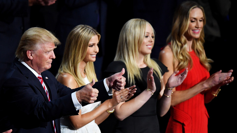 Donald, Ivanka, Tiffany and Lara Trump applauding themselves on stage