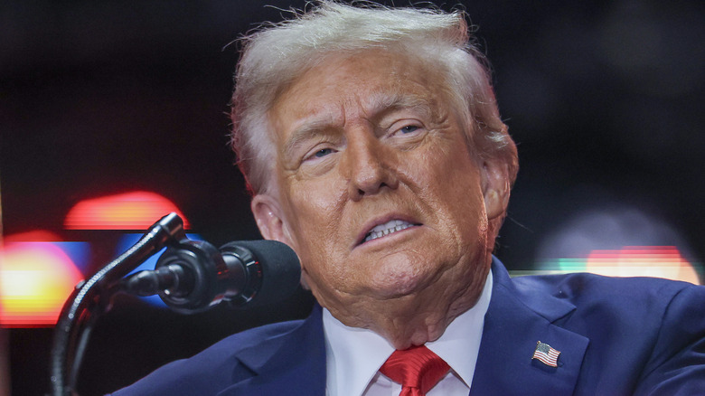 Closeup of Donald Trump talking into microphone at podium