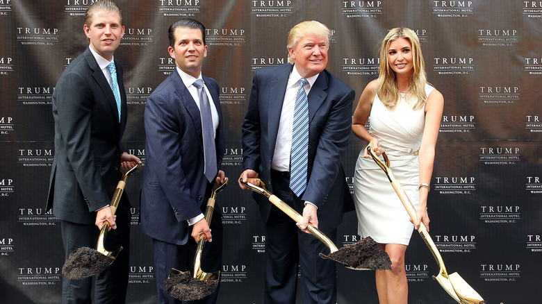 Eric Trump, Donald Trump Jr., Donald Trump, and Ivanka Trump breaking ground with golden spades