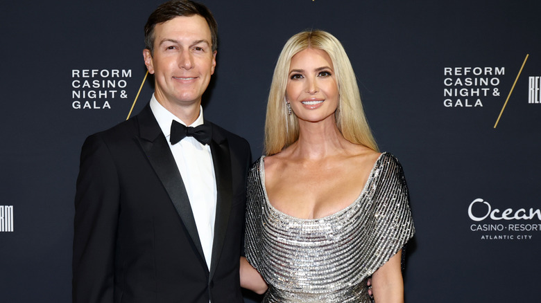 Jared Kushner and Ivanka Trump posing on step-and-repeat