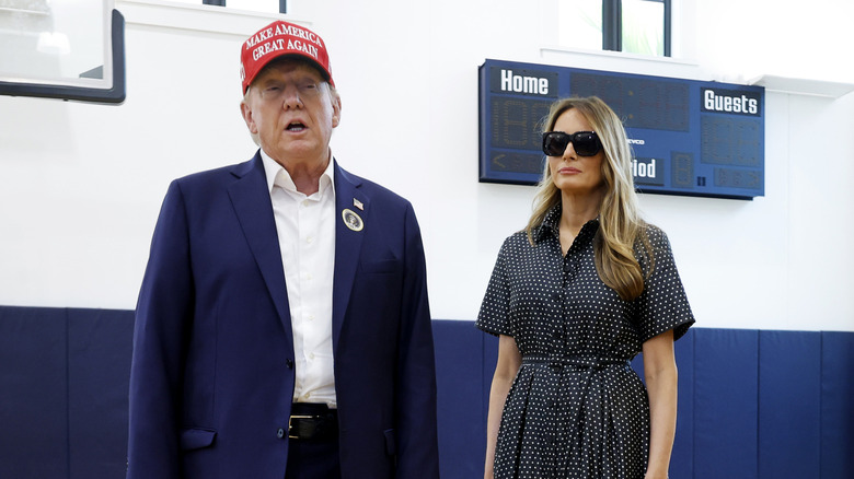 Donald Trump and his wife Melania Trump talk to reporters after casting their votes at the polling place in the Morton and Barbara Mandel Recreation Center on Election Day, on November 05, 2024 in Palm Beach, Florida.