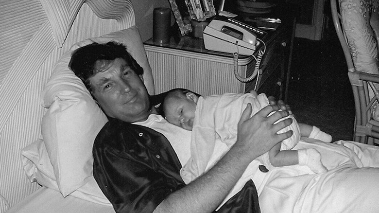 A young Donald Trump holds newborn daughter Tiffany Trump