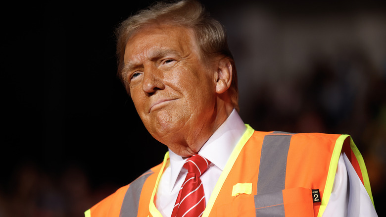 Donald Trump in reflective vest smiling