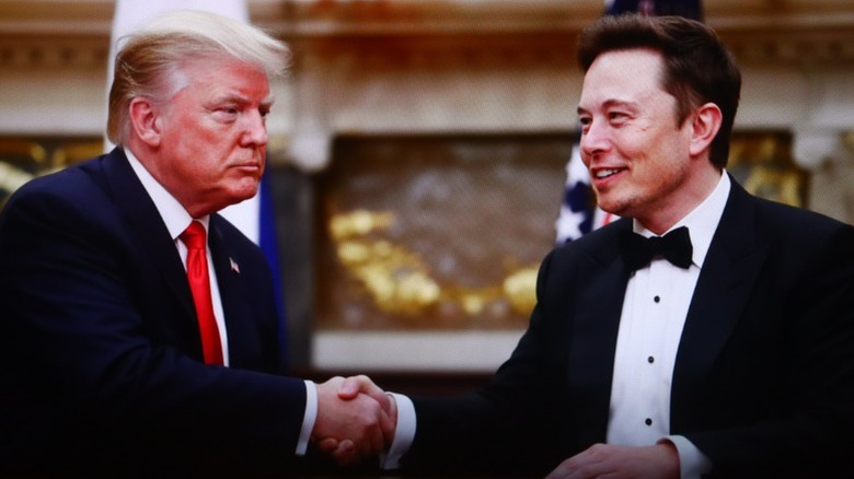 Elon Musk and Donald Trump shake hands during a meeting (2025)