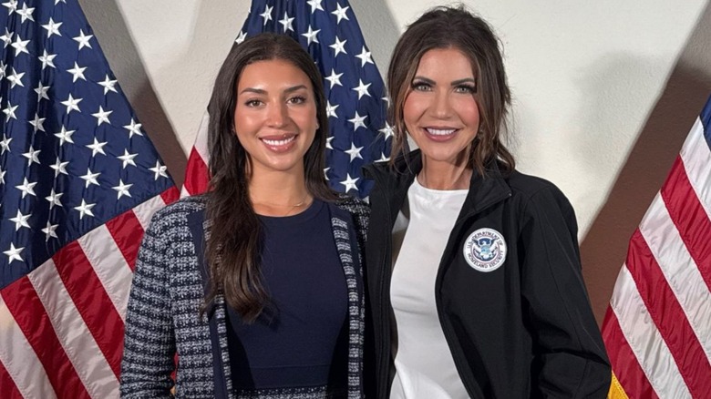 Deputy Assistant Secretary for Counterterrorism Julia Varvaro posing with Kristi Noem in front of American flags.