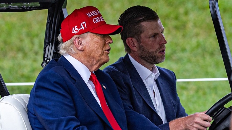 Donald Trump talking to Eric Trump in a golf cart