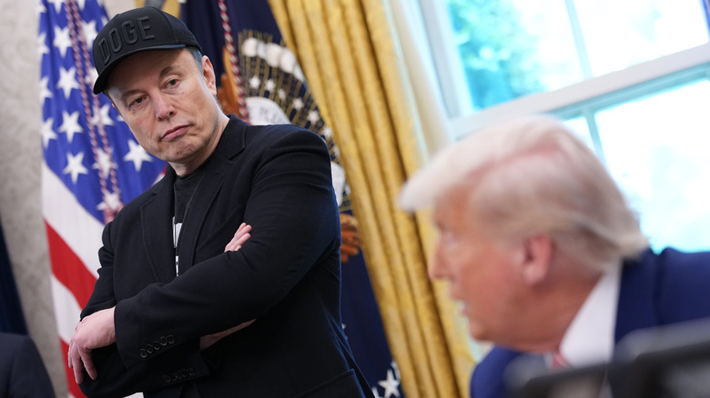 Elon Musk looking at Donald Trump