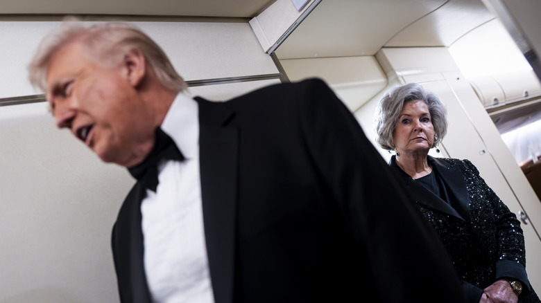 Susie Wiles standing behind Donald Trump on Air Force One