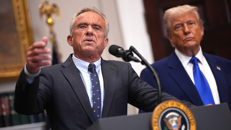 Robert F. Kennedy Jr. talking while Donald Trump looks on