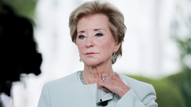 Linda McMahon adjusting her collar
