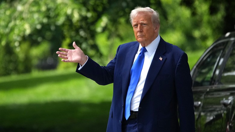 Donald Trump walks with his hand out