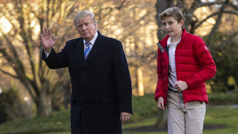 Donald Trump waving with Barron in red jacket
