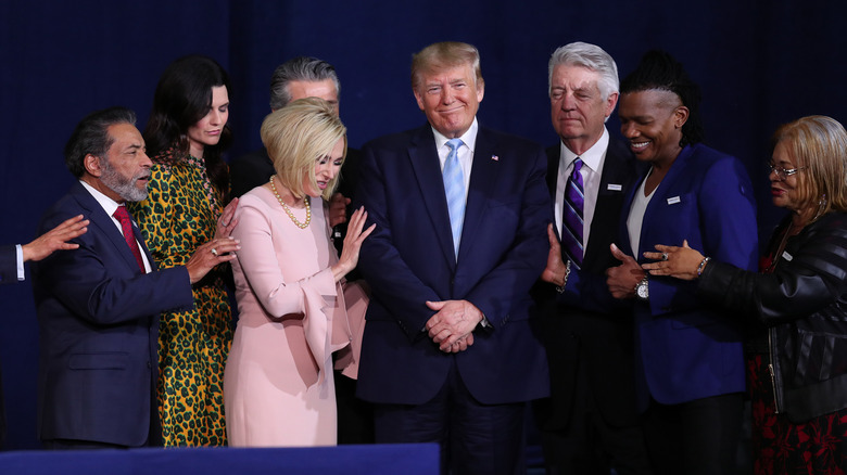 Faith leaders praying over Donald Trump