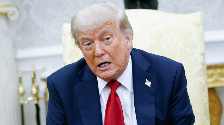 Donald Trump sits in the Oval Office
