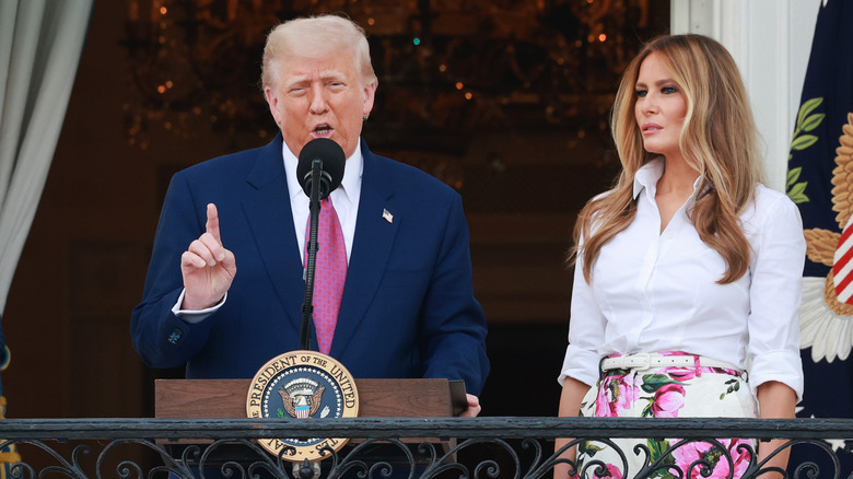 Donald Trump and Melania Trump speaking at podium