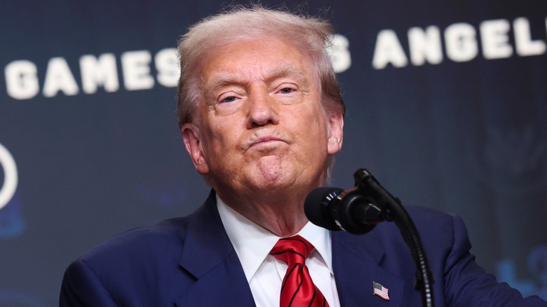 Donald Trump pursing his lips at a podium