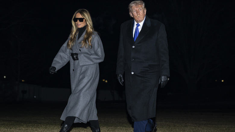 Donald Trump and Melania Trump walking together at night