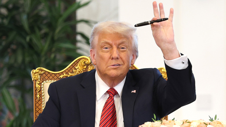 Donald Trump holding a pen