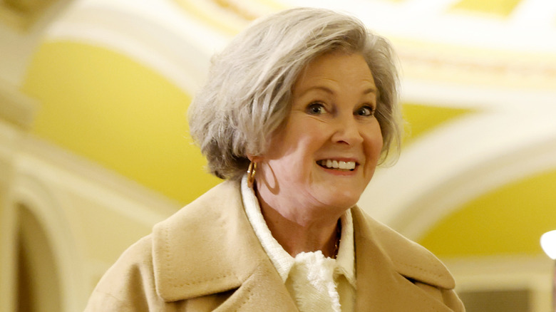 Susie Wiles smiling and glancing to the side