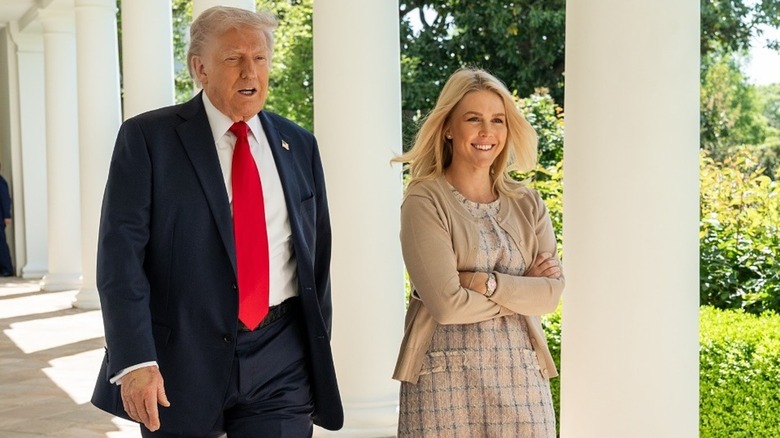 Donald Trump walking with Karoline Leavitt