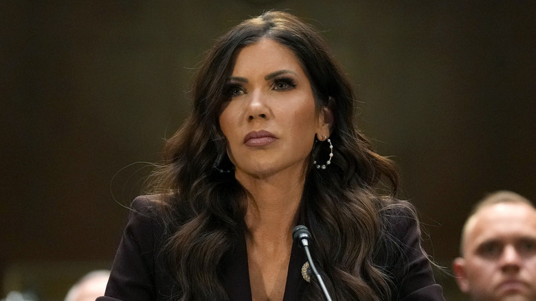 Closeup of Kristi Noem in front of microphone