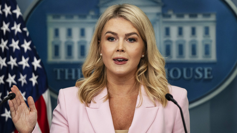 White House Press Secretary Karoline Leavitt standing on podium answering questions