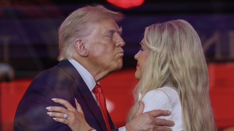 Donald Trump leaning in to kiss Erika Kirk