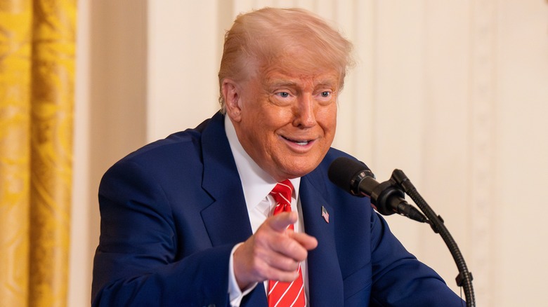 Donald Trump pointing while speaking at a podium in the White House
