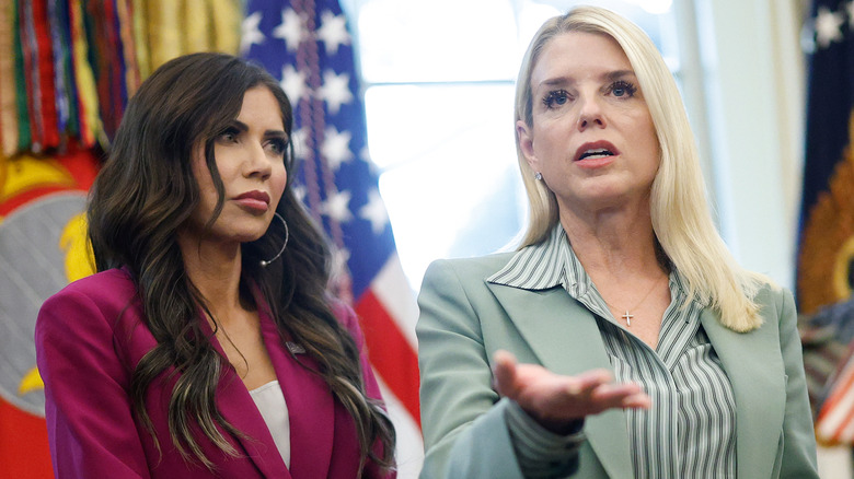Kristi Noem looking on as Pam Bondi speaks