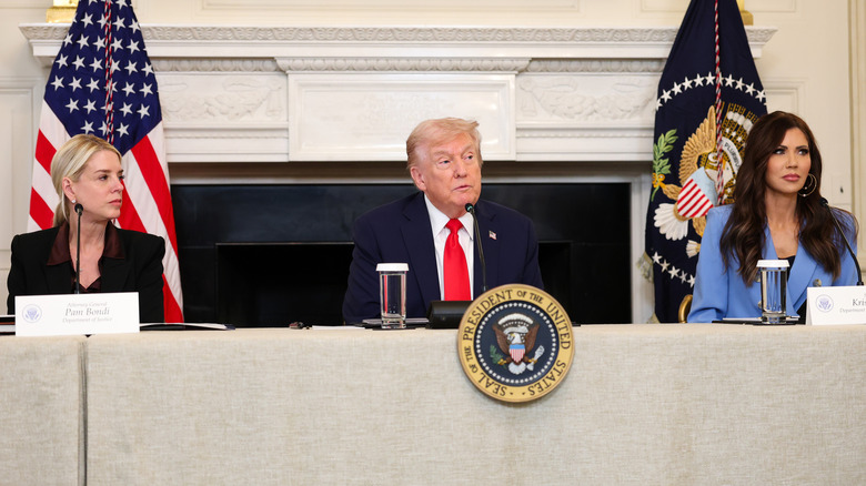 Donald Trump sitting between Pam Bondi and Kristi Noem