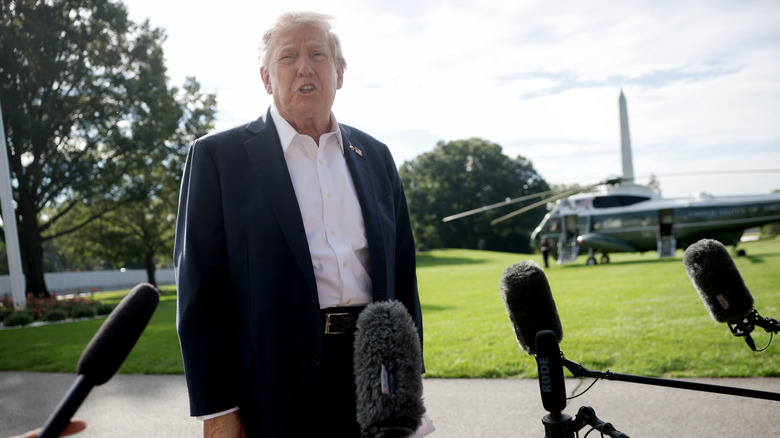 Donald Trump surrounded by microphones