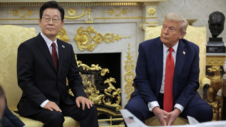 Donald Trump and South Korean President Lee Jae-myung seated in front of the fireplace in the Oval Office