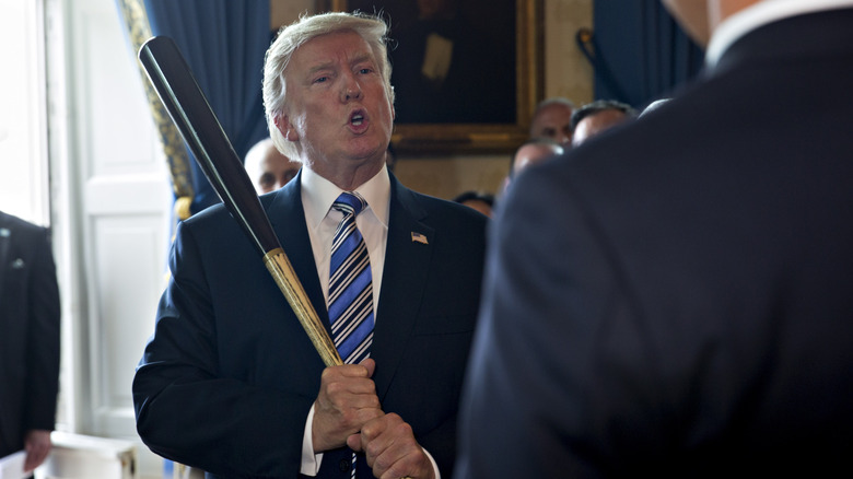 Donald Trump holding a baseball bat in the White House