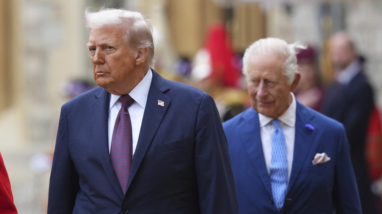 Donald Trump walking in front of King Charles III