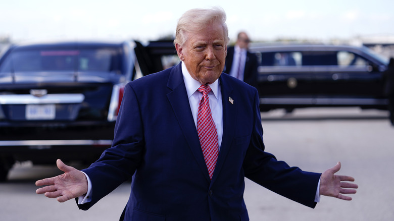 Donald Trump gesturing on the tarmac