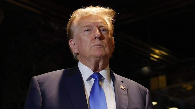 Donald Trump standing straight and tall and staring ahead